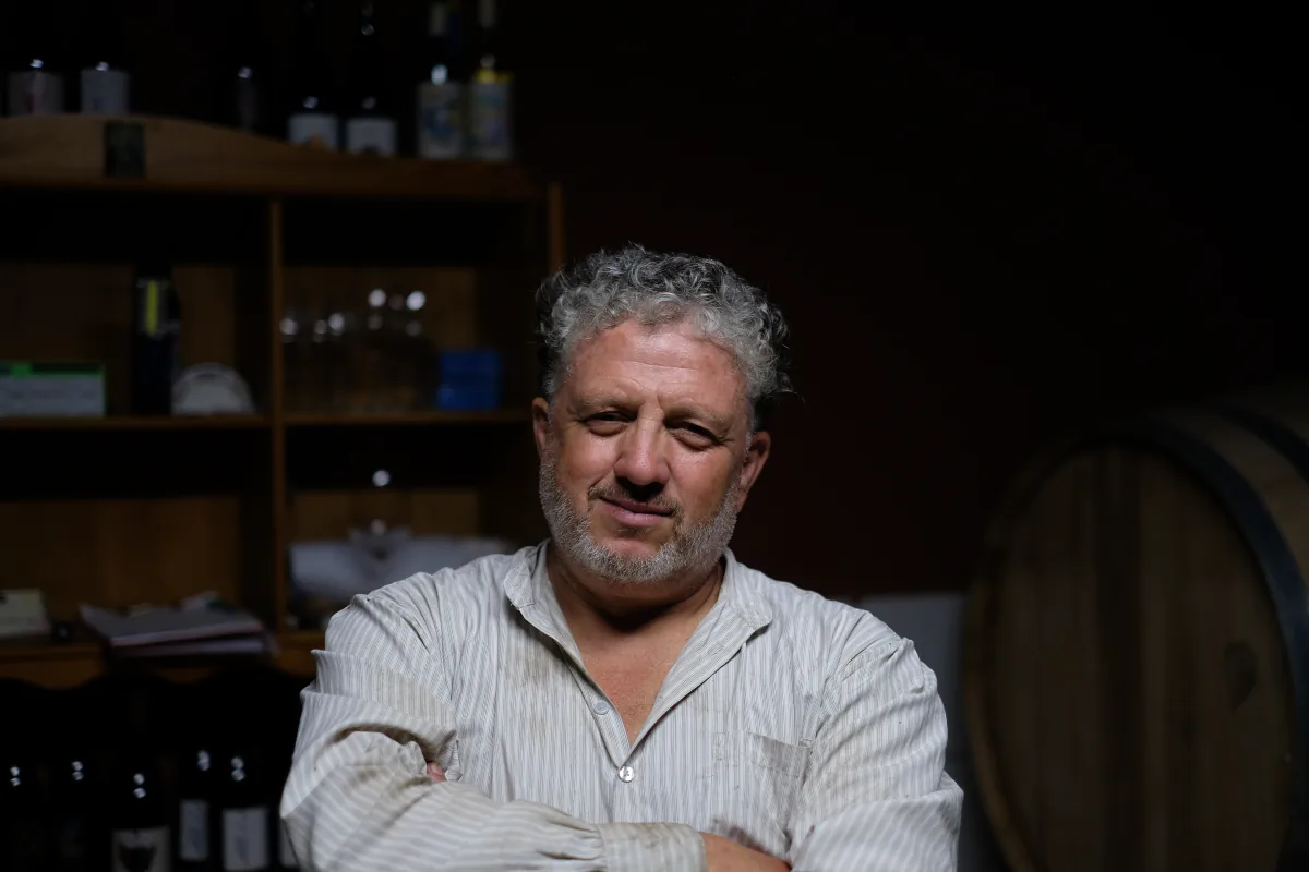 Claudio Miguel Luis Lorenzo seated in the tasting room at his house.