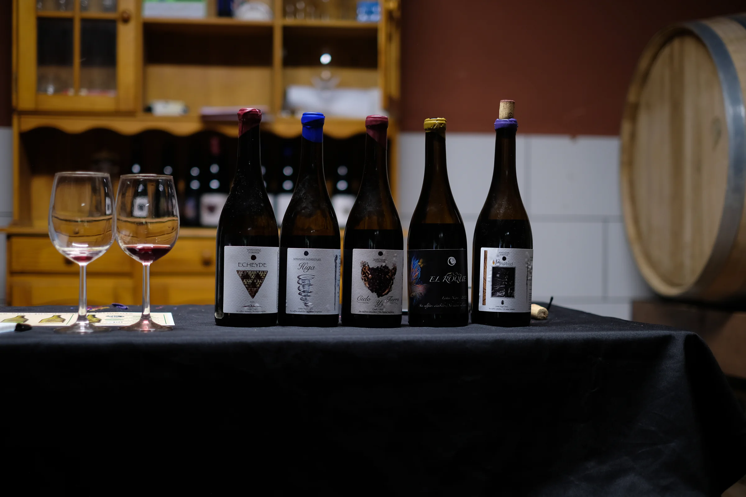 Five bottles of Marzagana Elementales wine on the tasting table, including El Roque.
